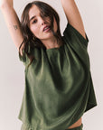 Woman wearing the Davis tee in bronze green against a plain background