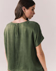 Back view of woman wearing the Davis tee in bronze green with matching Lee trousers, shot on a white background.
