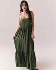 Woman wearing the Berkeley Maxi Flowy Silky Dress in Green against a white background