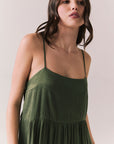 Close up of woman wearing the Berkeley Maxi Flowy Silky Dress in Green against a white background