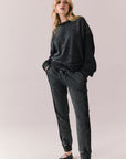 Full front view of Maritime Pullover in True Black with relaxed fit and knit texture and matching Bay Joggers against a plain background