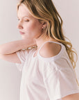 Side view of Northridge Tee in white with cold shoulder cutout against a plain background