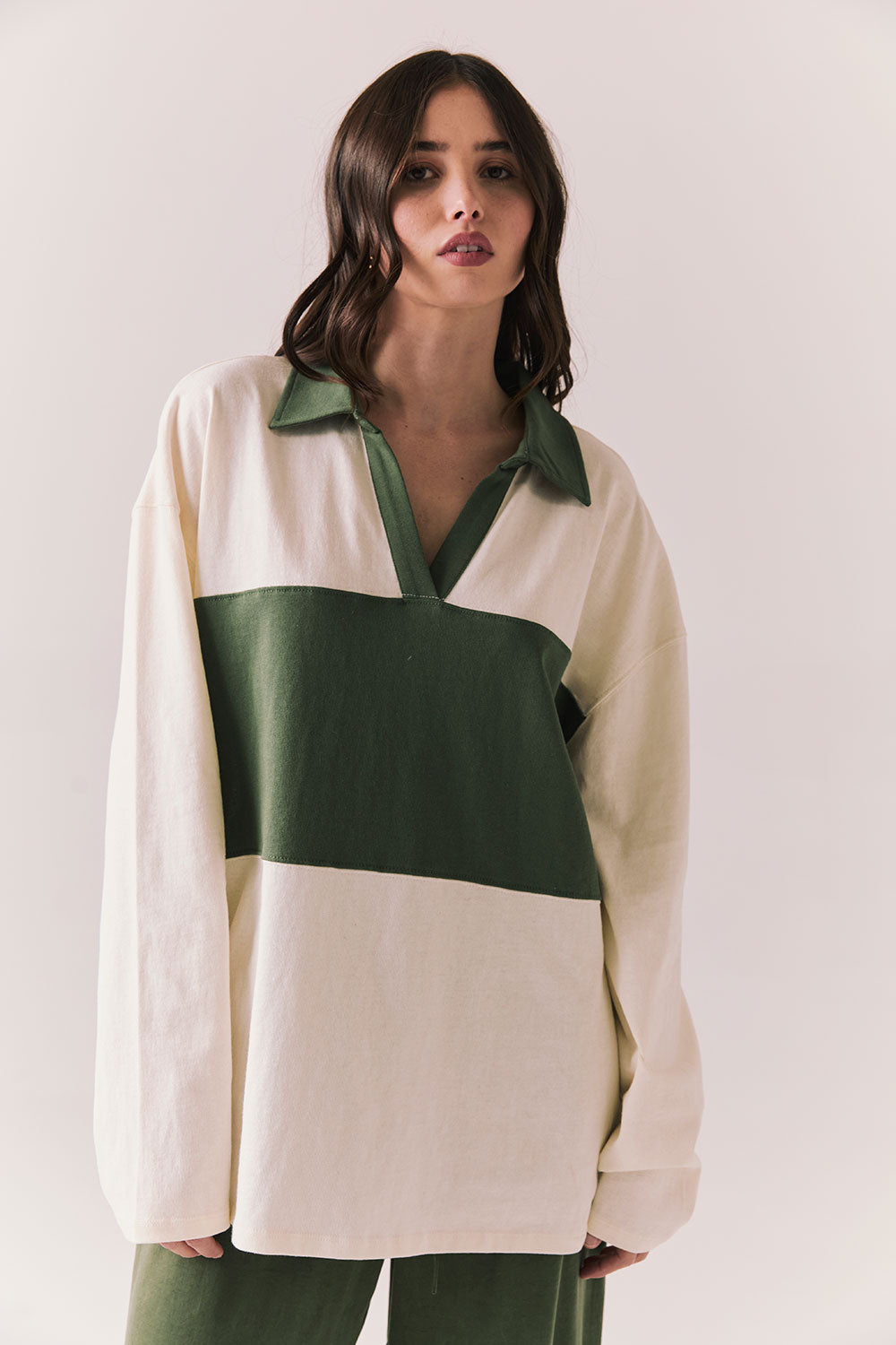 Woman wearing the color-blocked Chico Long Sleeve White and Green Rib Pullover on a white background