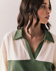 Close up of woman wearing the color-blocked Chico Long Sleeve White and Green Rib Pullover on a white background