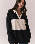 Front view of woman wearing a black and white Chico long sleeve with striped design against a plain background