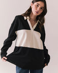 Front view of woman wearing a black and white Chico long sleeve with striped design against a plain background