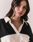 Front view of woman wearing a black and white Chico long sleeve with striped design against a plain background