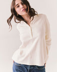 Front view of model wearing the Humboldt long sleeve in starry white with soft cotton texture and blue jeans against a white background
