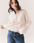 Front view of model wearing the Humboldt long sleeve in starry white with soft cotton texture and blue jeans against a white background