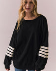 Front view of Pomona Long Sleeve in black and white with bold stripes and gigot sleeves against a plain background