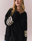 Front view of Pomona Long Sleeve in black and white with bold stripes and gigot sleeves against a plain background