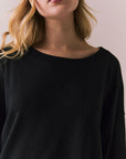 Closeup view of Pomona Long Sleeve in black and white with bold stripes and gigot sleeves against a plain background