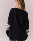 Back view of Pomona Long Sleeve in black and white with bold stripes and gigot sleeves against a plain background