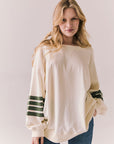 Front view of Pomona long sleeve in Starry White with Bronze Green stripes and gigot sleeves against a plain background
