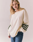 3/4 view of Pomona long sleeve in Starry White with Bronze Green stripes and gigot sleeves against a plain background