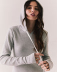 Front view of model wearing Merced Hoodie Dress in Heather Grey with hood and thermal knit texture against a plain background