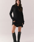 Front full body view of model in Merced Hoodie Dress in True Black with hood against a plain background