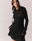 Front view of model in Merced Hoodie Dress in True Black with hood against a plain background