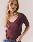 Front view of Fresno tee in fig with scoop neck and fitted silhouette on a plain background