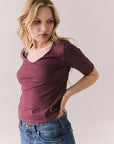 Side view of Fresno tee in fig with scoop neck and fitted silhouette on a plain background