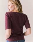 Back view of Fresno tee in fig with scoop neck and fitted silhouette on a plain background