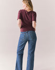 Full back view of Fresno tee in fig with scoop neck and fitted silhouette and denim on a plain background