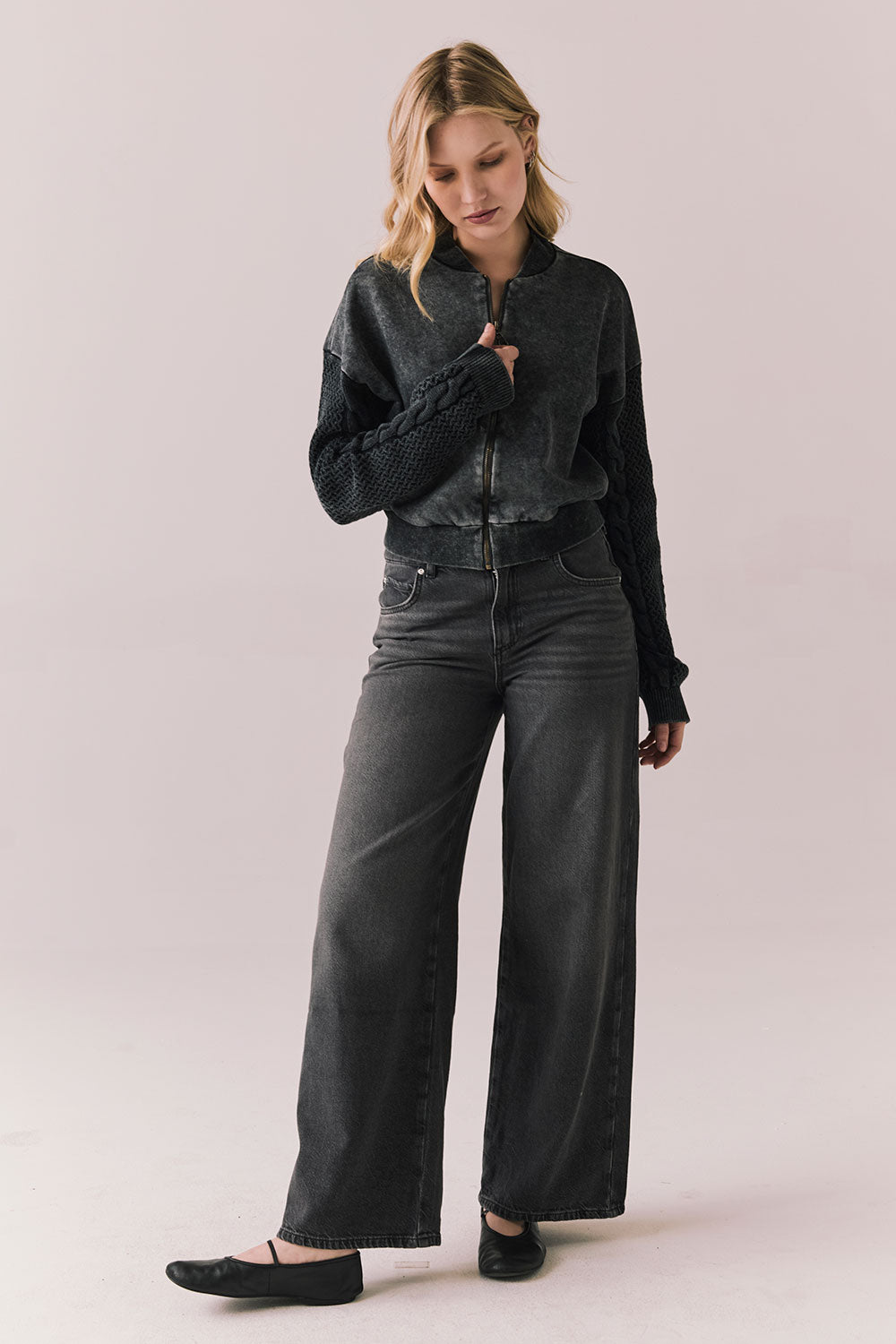 Full body view of Fullerton hoodie in True Black with oversized silhouette with black jeans on a plain background