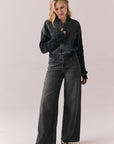 Full body view of Fullerton hoodie in True Black with oversized silhouette with black jeans on a plain background