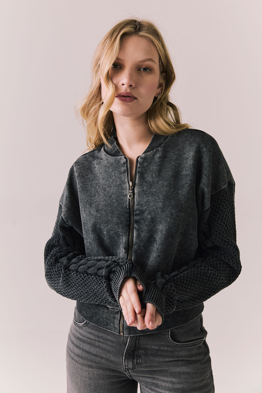 Front view of Fullerton hoodie in True Black with oversized silhouette with black jeans on a plain background