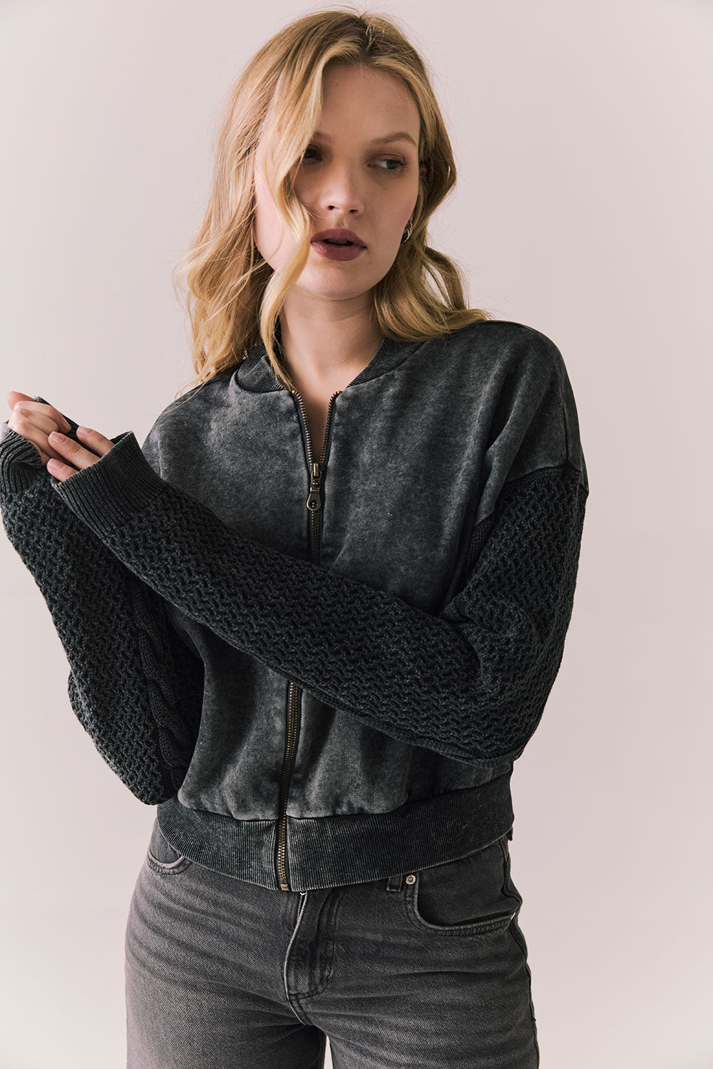 Front view of Fullerton hoodie in True Black with oversized silhouette with black jeans on a plain background