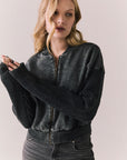 Front view of Fullerton hoodie in True Black with oversized silhouette with black jeans on a plain background