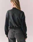 Back view of Fullerton hoodie in True Black with oversized silhouette with black jeans on a plain background