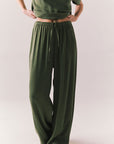 Front view of Lee Trouser in bronze green with wide-leg silhouette and relaxed drape against a plain background