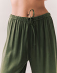 Closeup view of Lee Trouser drawstring in bronze green with wide-leg silhouette and relaxed drape against a plain background