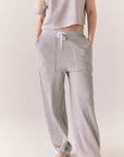 Front view of model wearing Billyy Joggers in heather grey
