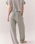 Back view of model wearing Billyy Joggers in heather grey
