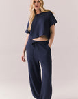 Full body view of model in Billyy Joggers in midnight blue with matching top.