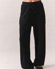 Front view of model wearing Billyy Joggers in true black