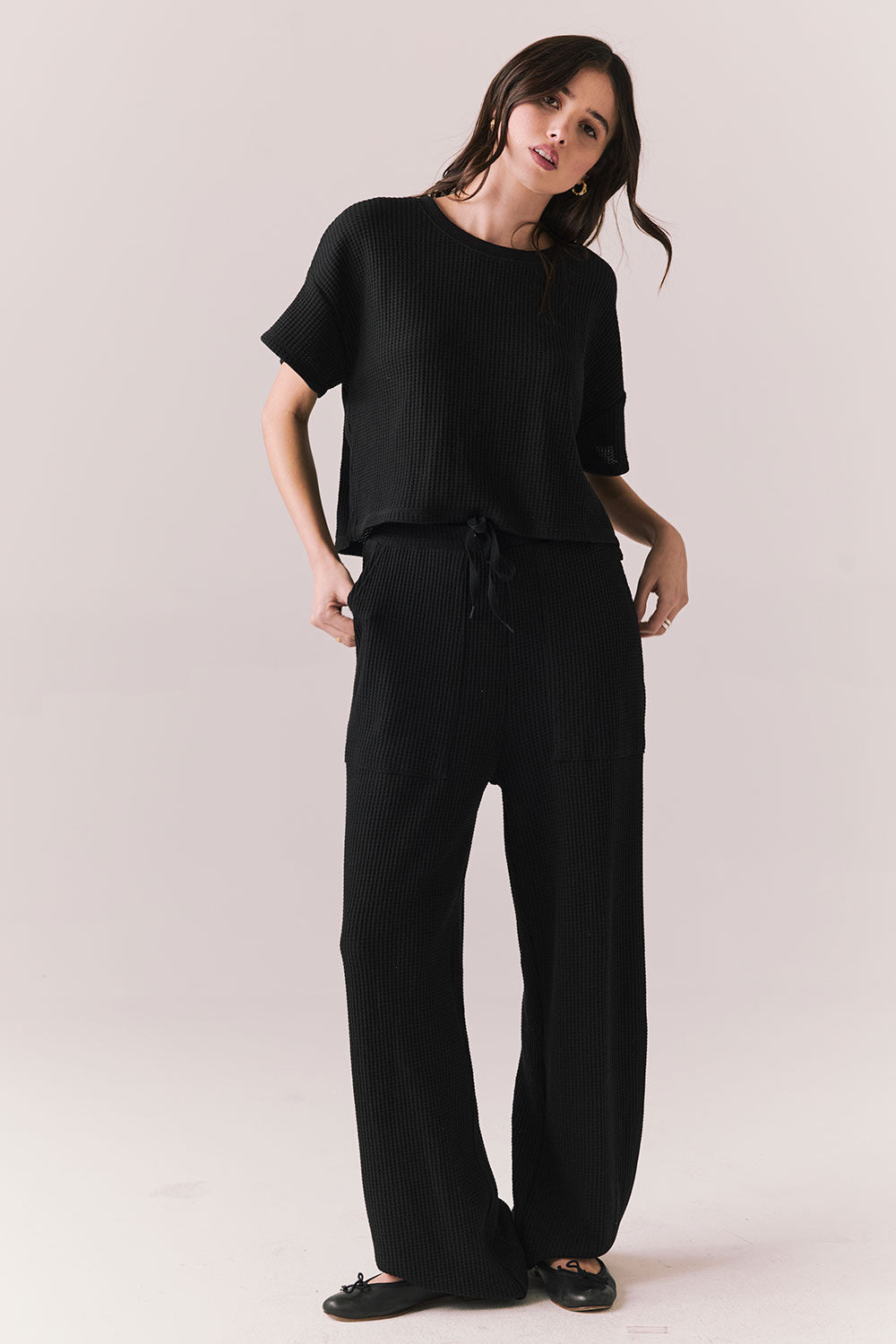 Full body view of model in Billyy Joggers in true black with matching top