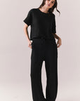 Full body view of model in Billyy Joggers in true black with matching top