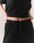 Closeup front view of model wearing Billyy Joggers in true black