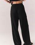 Back view of model wearing Billyy Joggers in true black