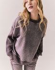 Front view of Maritime Pullover in fig (deep purple) with relaxed fit and knit texture against a plain background