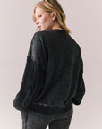 Back view of Maritime Pullover in True Black with relaxed fit and knit texture against a plain background