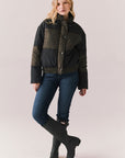 Full body view of Chaser Brand Whistler Leopard and True Black Puffer Jacket paired with dark denim and black boots