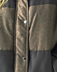 Closeup of Chasers Whistlerrr Leopard and True Black Puffer Close-up of Chaser Brand Whistler Leopard and True Black Puffer Jacket showing tonal leopard texture and snap-front detail
showing the leopard print