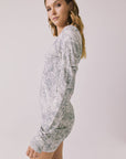 Side view of woman wearing Chaser’s Ziggy Python Print Mini Dress showing python print detail on a white background