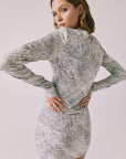 Back view of woman wearing Chaser’s Ziggy Python Print Mini Dress on a white background