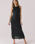 Full body view of woman wearing Chaser’s Faye True Black Dress on a white background