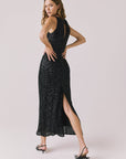 Full body back view of woman wearing Chaser’s Faye True Black Dress on a white background
